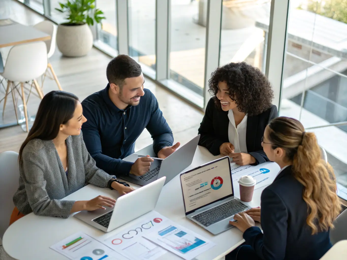 A professional workspace featuring a team collaborating on business strategies, with digital displays showing growth metrics and automation workflows.